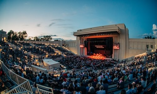 a crowd watching an outdoor stage