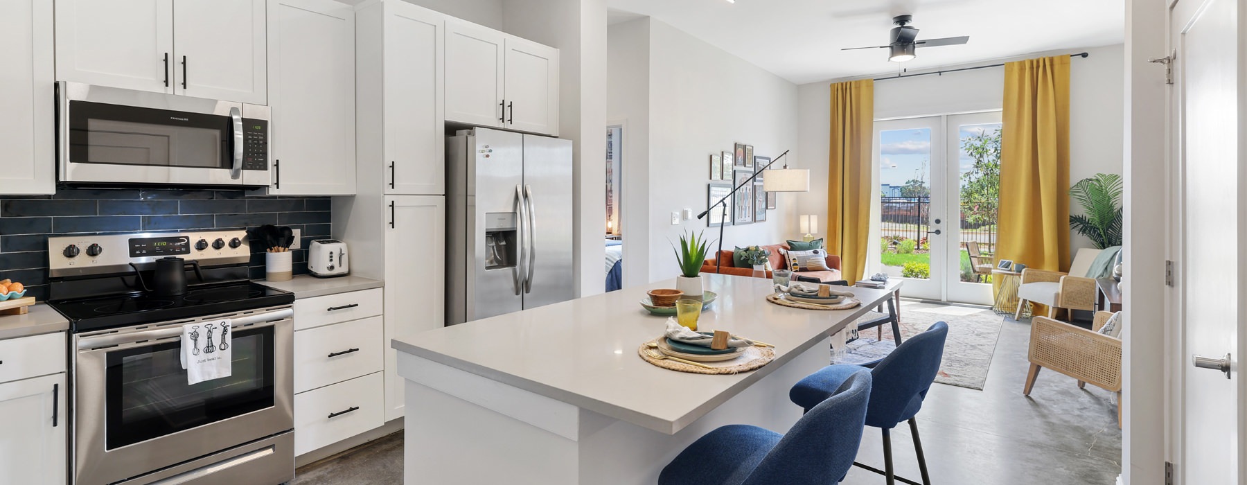 Chef-inspired kitchens with stainless steel appliances in apartments at Metronome at MidCity