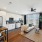 Open Kitchen and living room with wood plank flooring and stainless steel appliances featuring dishwasher, oven, and microwave with dining room