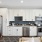 Kitchen with wood plank flooring and stainless steel appliances featuring dishwasher, oven, refrigerator, and microwave