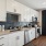 Open Kitchen with wood plank flooring and stainless steel appliances featuring dishwasher, oven, and microwave